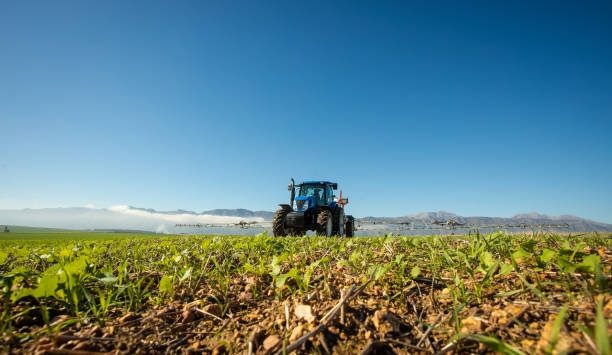 Tractor working a field with crop residue on the surface